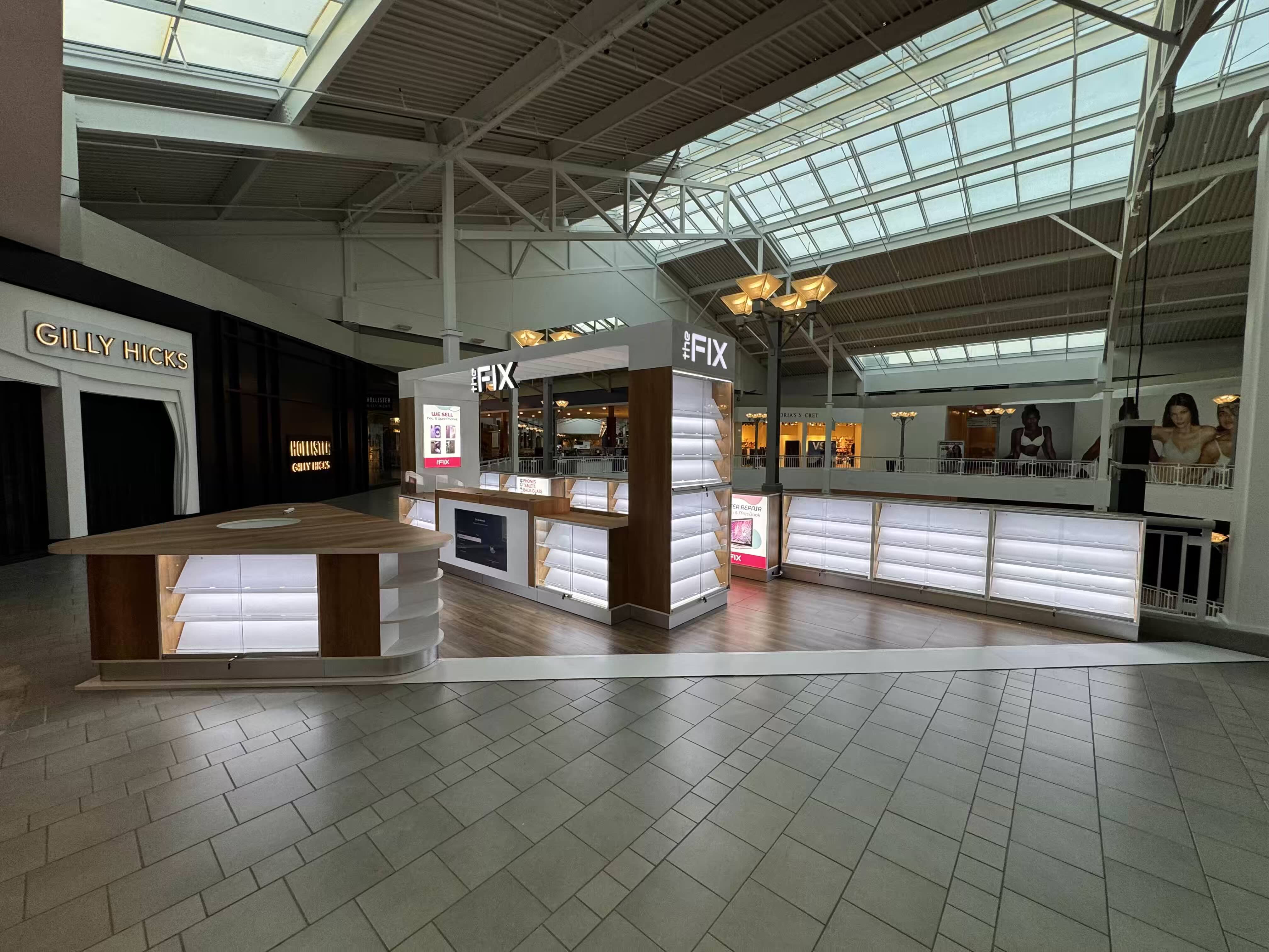 The Fix kiosk at Bridgewater Commons mall — illuminated displays under a skylit atrium